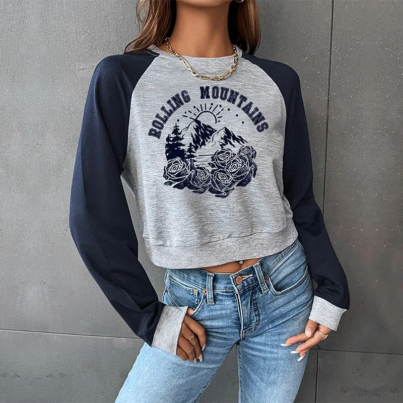 Damen Cropped Raglan-Sweatshirt mit Bergmotiv, gerafftem Saum und Kontrastärmeln Nord Taschen