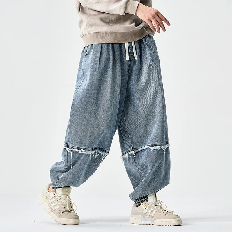 Herren Weit geschnittene Baggy-Denim-Hose mit Tunnelzug, elastischen Beinabschlüssen und Fransen-Detail Nord Taschen