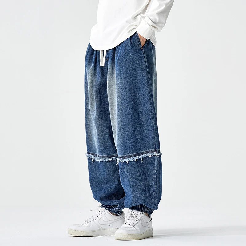 Herren Weit geschnittene Baggy-Denim-Hose mit Tunnelzug, elastischen Beinabschlüssen und Fransen-Detail Nord Taschen