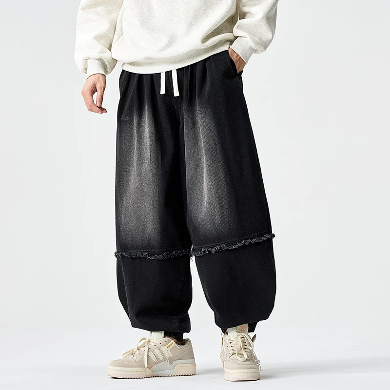 Herren Weit geschnittene Baggy-Denim-Hose mit Tunnelzug, elastischen Beinabschlüssen und Fransen-Detail Nord Taschen