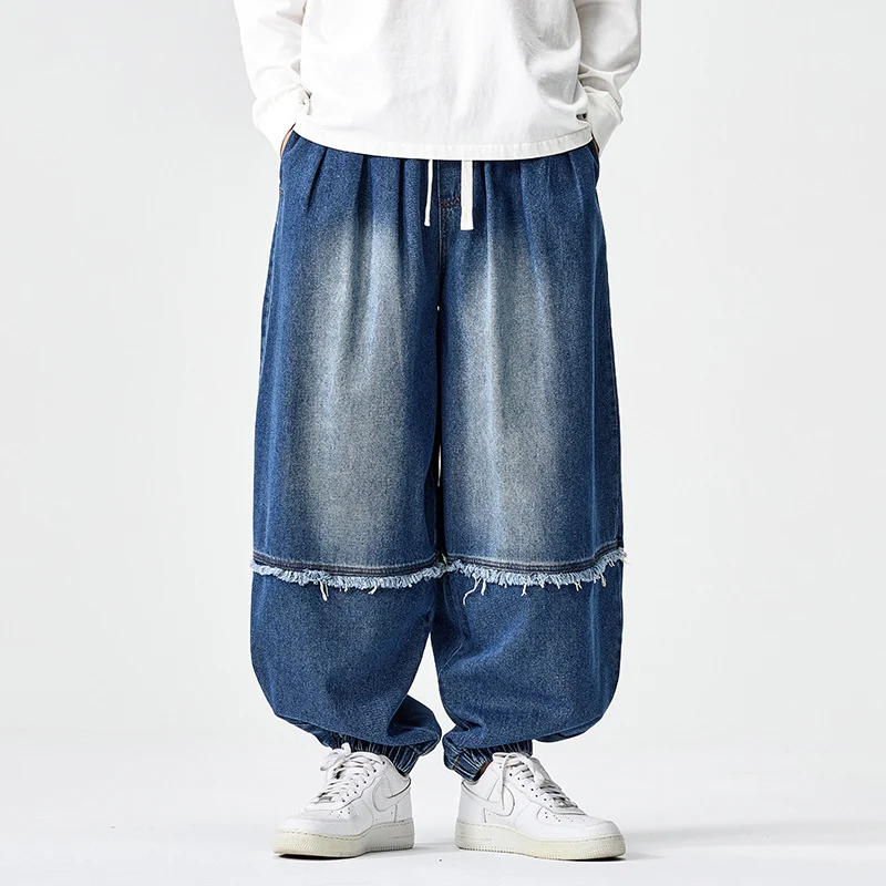 Herren Weit geschnittene Baggy-Denim-Hose mit Tunnelzug, elastischen Beinabschlüssen und Fransen-Detail Nord Taschen