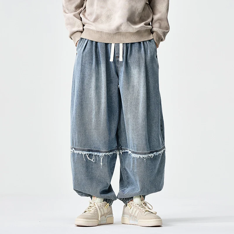 Herren Weit geschnittene Baggy-Denim-Hose mit Tunnelzug, elastischen Beinabschlüssen und Fransen-Detail Nord Taschen